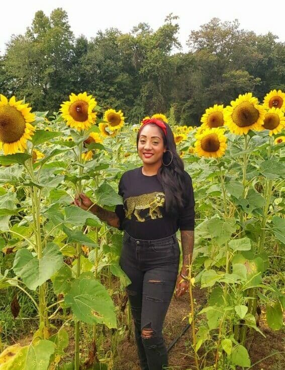 Nicole in a field of sunflowers.