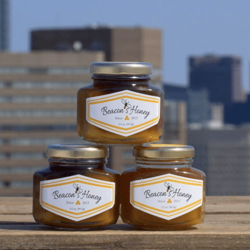 custom branded honey jars three jars stacked on a corporate beekeeping client rooftop