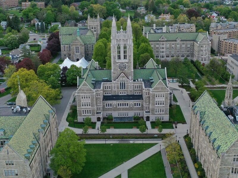 arial shot of Boston College showing green lawns and gothic architecture