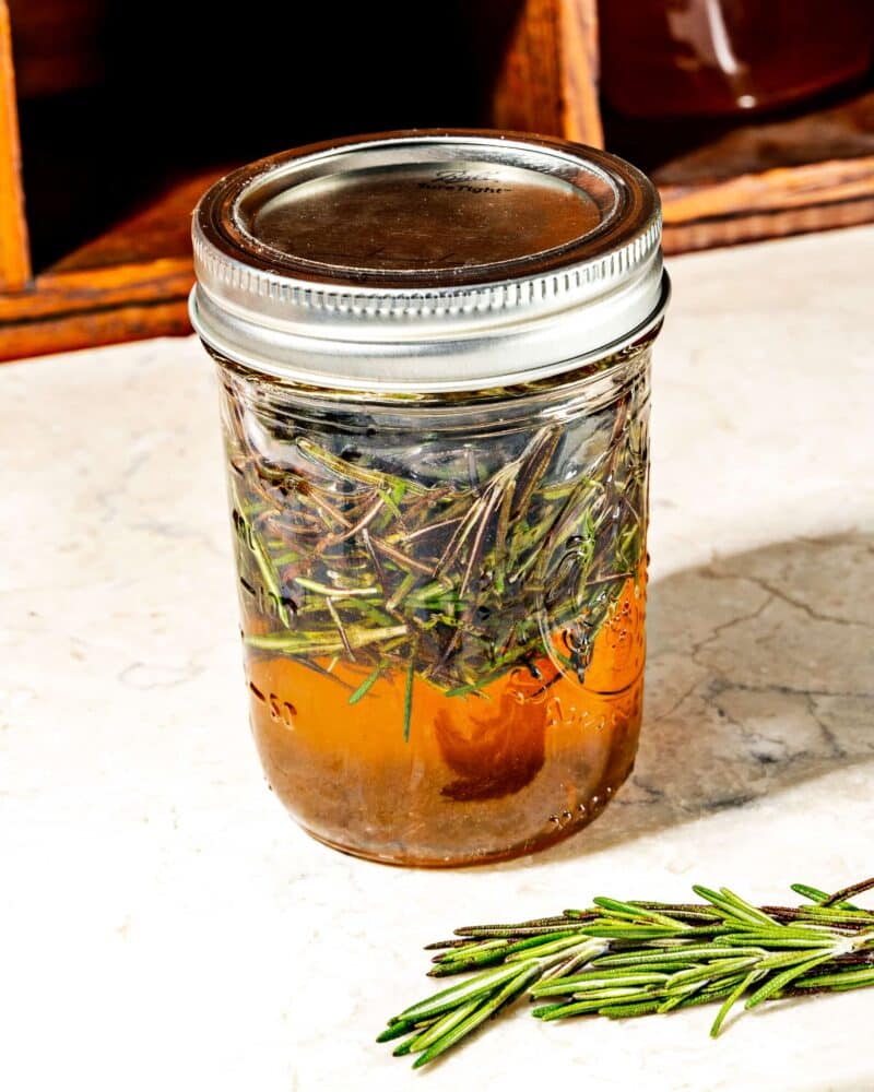 honey infused with rosemary in a glass mason jar