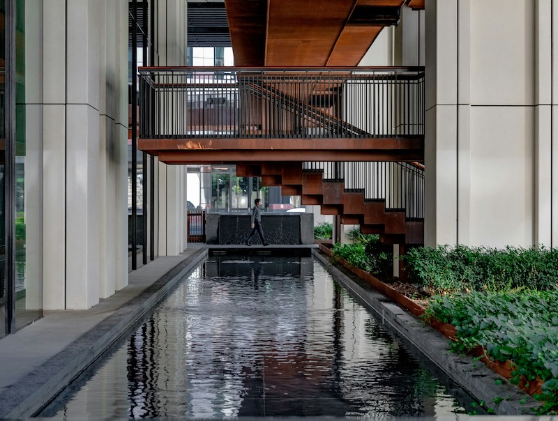 Interior of Barbican Centre, displaying biophilia and biophilia design with water features, natural materials, and greenery