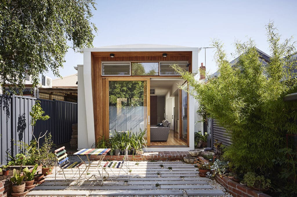 This backyard, with its permeable pavers forming the patio, exemplifies sustainable design.