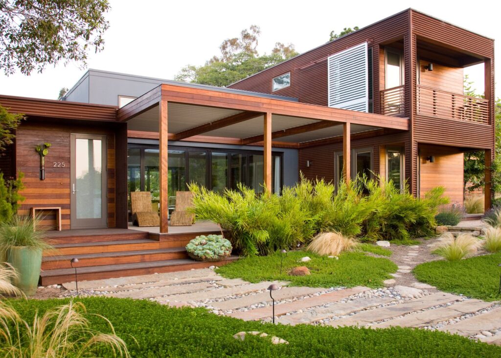 This mid-century modern house incorporates elements of sustainable design with its stone walkway and clover lawn