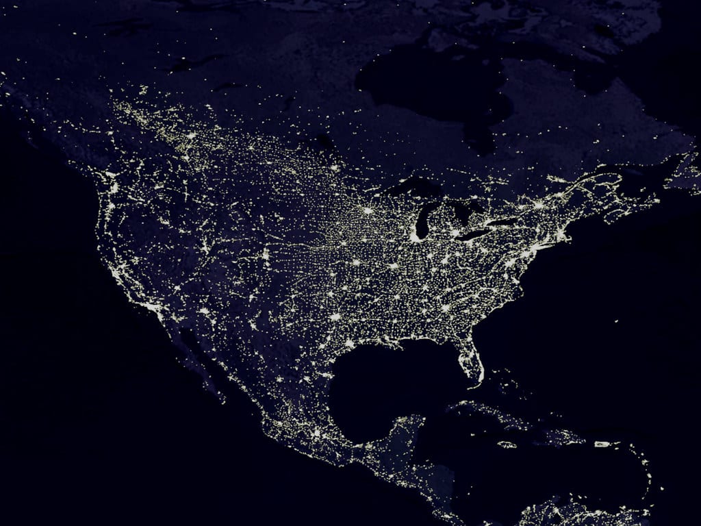 Climate change and bees includes the way increasing human development, shown here in this image of the US lit up at night by its cities, impacts pollinator habitat