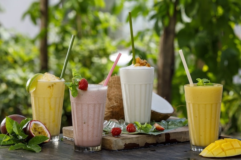 four different smoothies on a table