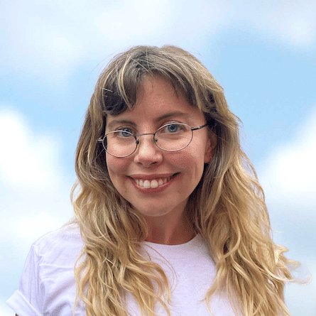 Paige Mulhern smiling against backdrop of a blue sky with white clouds